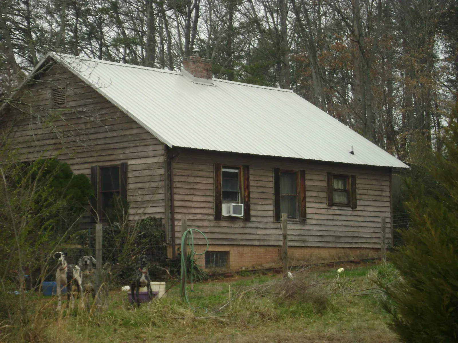 White metal roof on an old wood sided farmhouse, from a Metal Roof Installation job in La Harpe